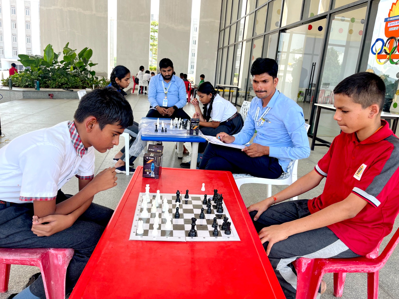 Students playing chess and sports
